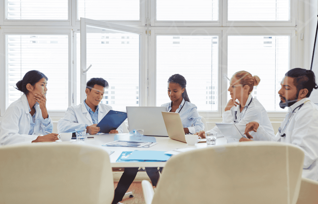 Healthcare team reviewing patient charts during medical records abstraction in healthcare process